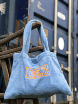Denim badstof tas met neon-oranje borduring